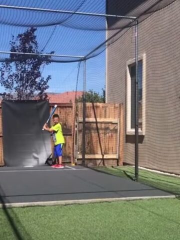 kids playing in a homemade batting cage