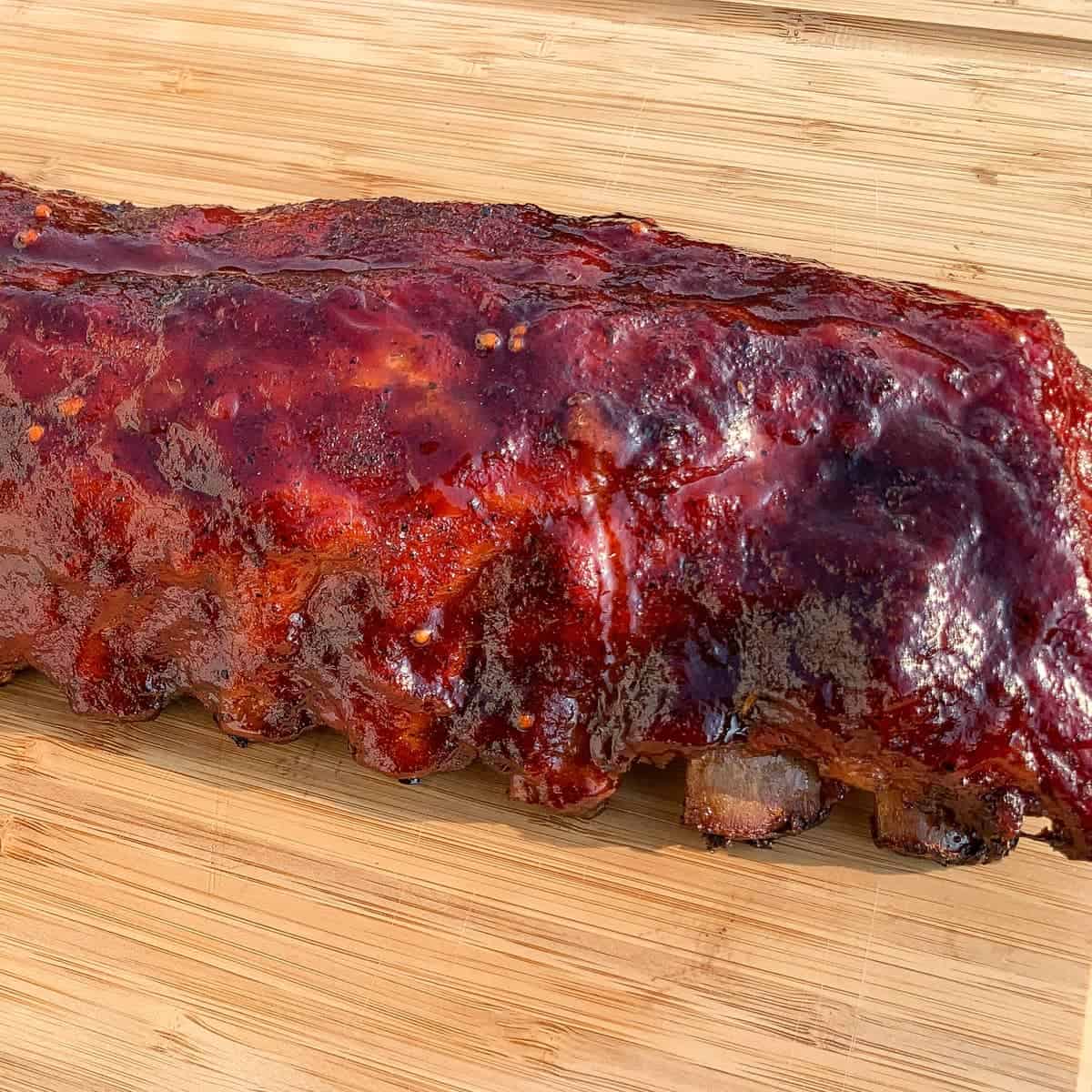 smoked baby back ribs on a cutting board