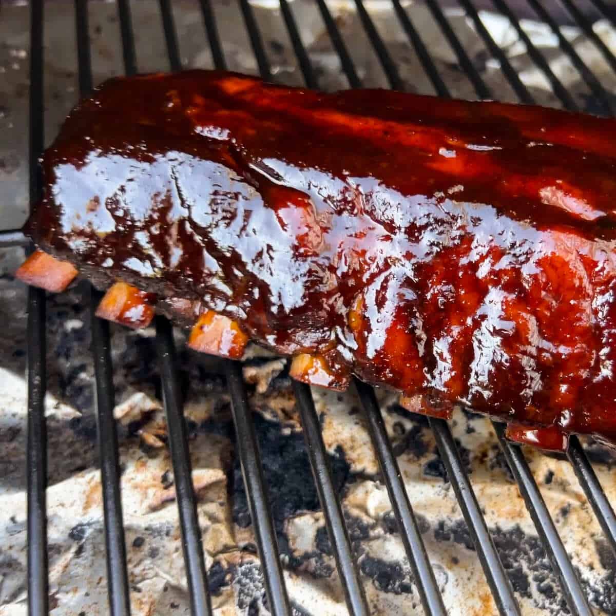 baby back ribs on the grates of a Traeger pellet grill