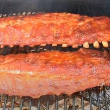 baby back ribs smoking on a pellet grill