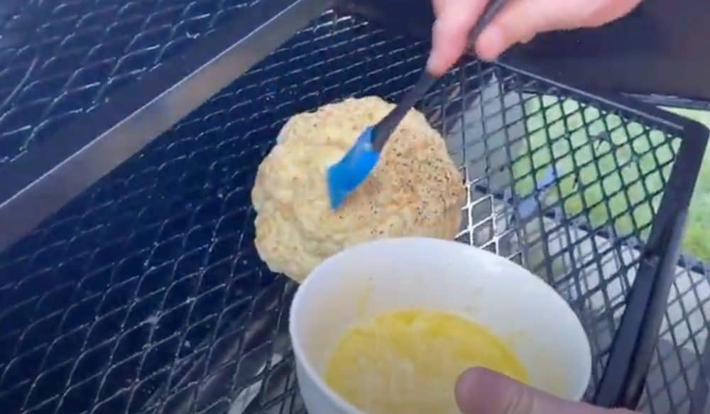 basting cauliflower on the smoker with butter