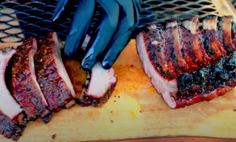 carving a slab of baby back ribs