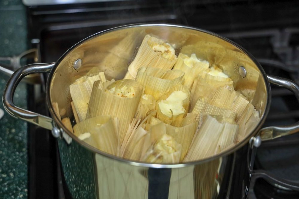 tamales steaming in a pot