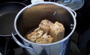 steaming tamales in a pot