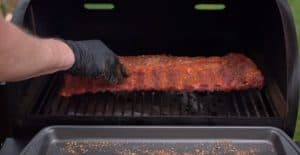 3-2-1 ribs being placed in a traeger to smoke