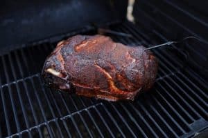 a pork butt smoking on a traeger pellet grill