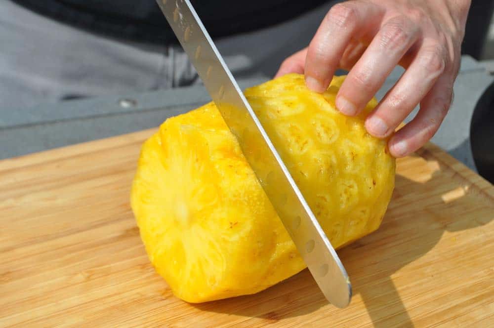 slicing a pineapple