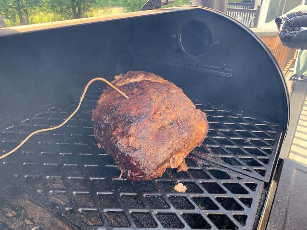 a pork butt smoking in a pit boss pellet grill