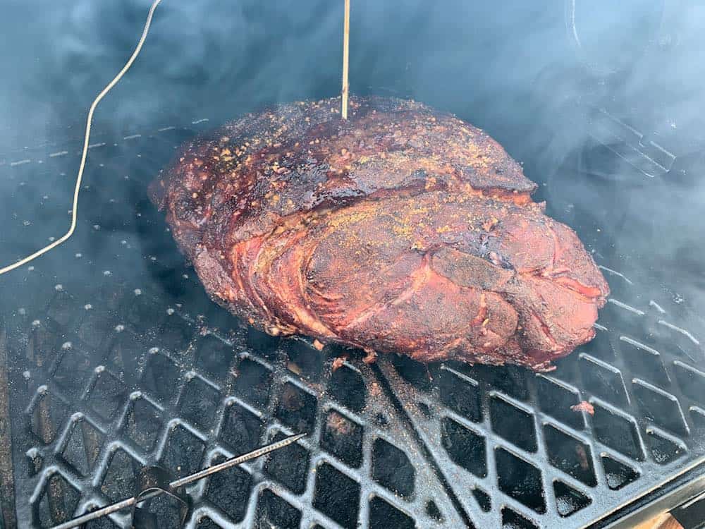 a pork butt smoking in a pit boss pellet grill