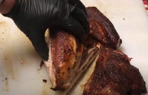 carving up a pellet grilled spatchcocked turkey