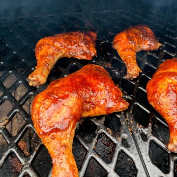 Chicken Leg Quarters on the grates of a pit boss pellet grill