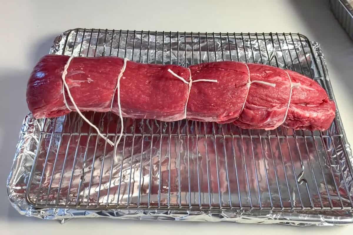 a beef tenderloin tied with kitchen twine