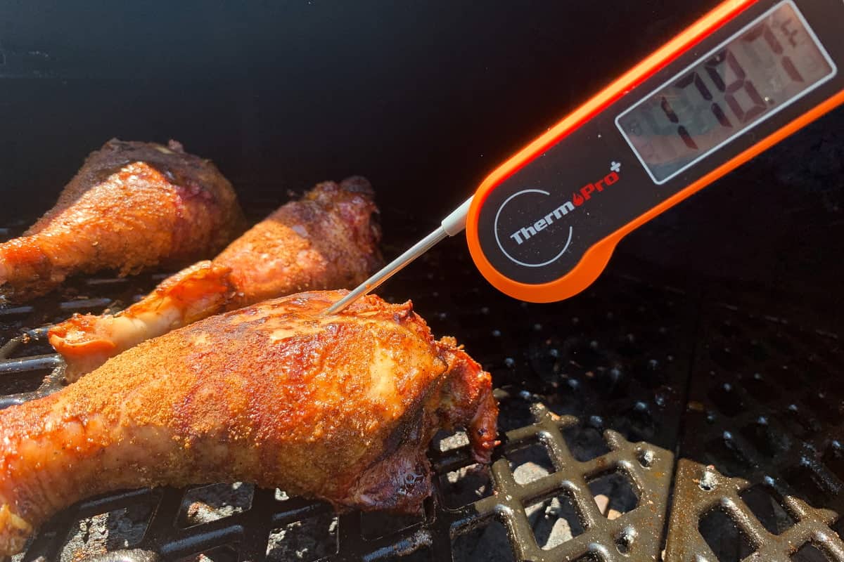 turkey legs with an instant read thermometer inserted measuring 178 degrees F