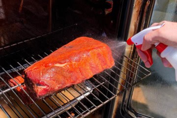 spraying ribs with apple cider vinegar and water mixture