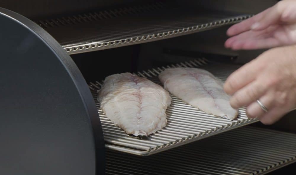 placing mackerel fillets on pellet grill to smoke