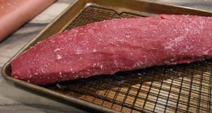 a beef tenderloin on a wire rack