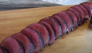 a finished pit boss smoked beef tenderloin on a cutting board