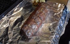 taking a smoked beef tenderloin off the smoker to rest