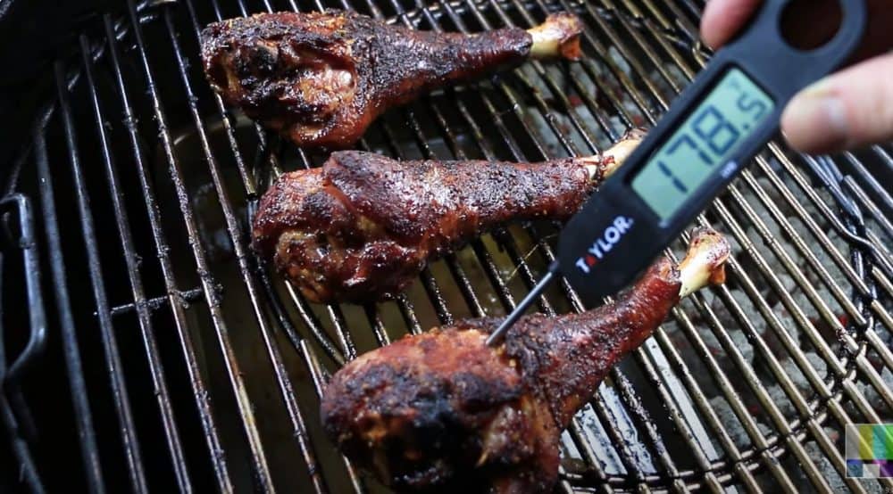 an instant thermometer reading 178°F on a smoked turkey leg