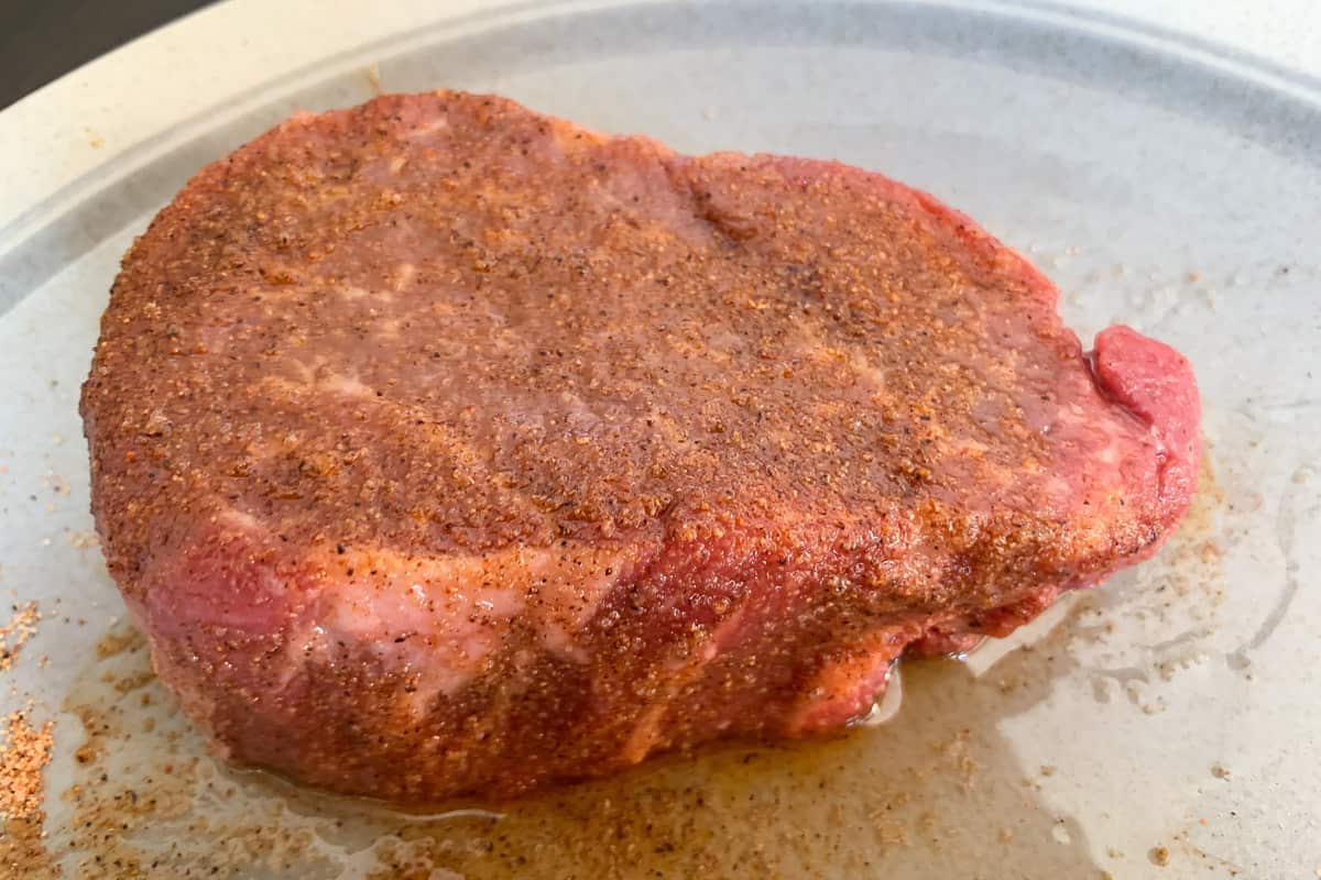 raw filet mignon with bbq rub on it