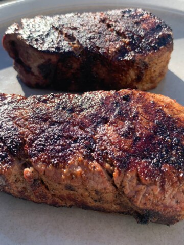 Two smoked filet mignon steaks on a plate