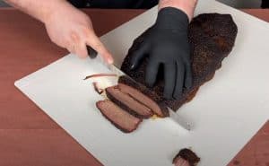slicing a pit boss pellet grill smoked beef brisket