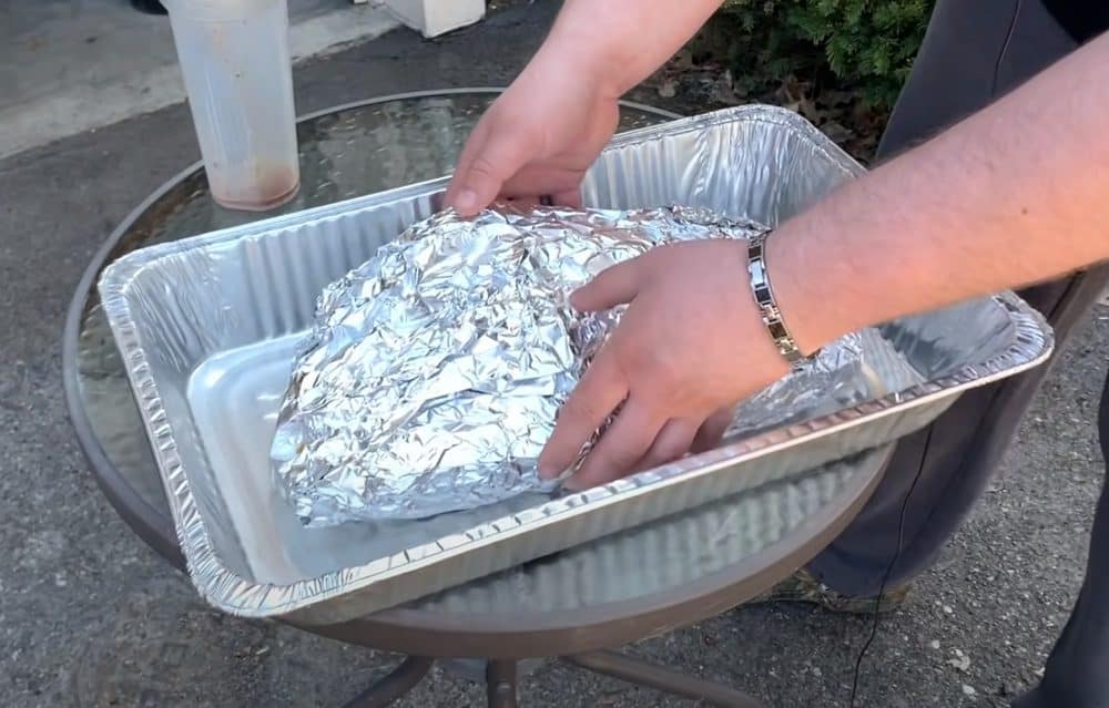 a wrapped smoked beef brisket going back in Masterbuilt Electric smoker