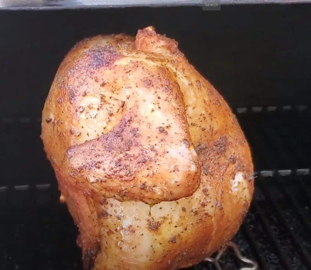 a beer can chicken smoking on a pellet grill