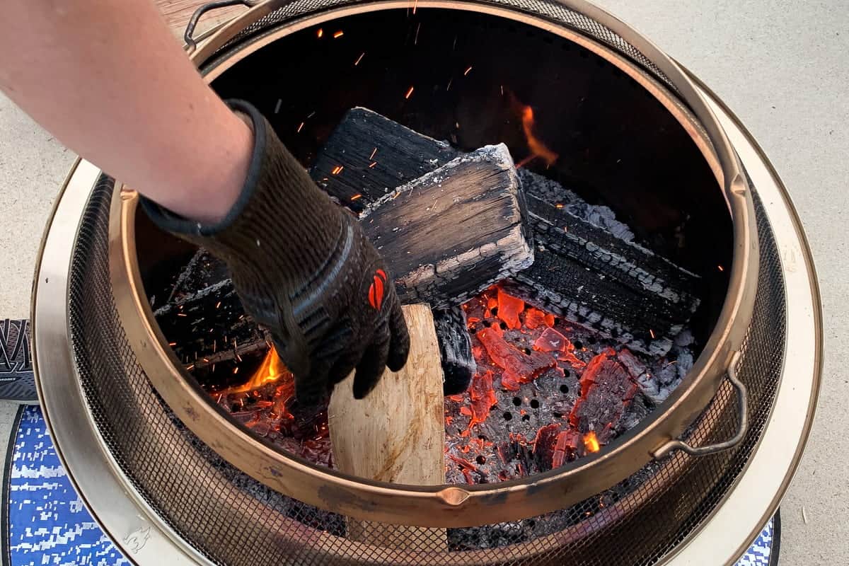 adding wood into a solo stove using the clock method