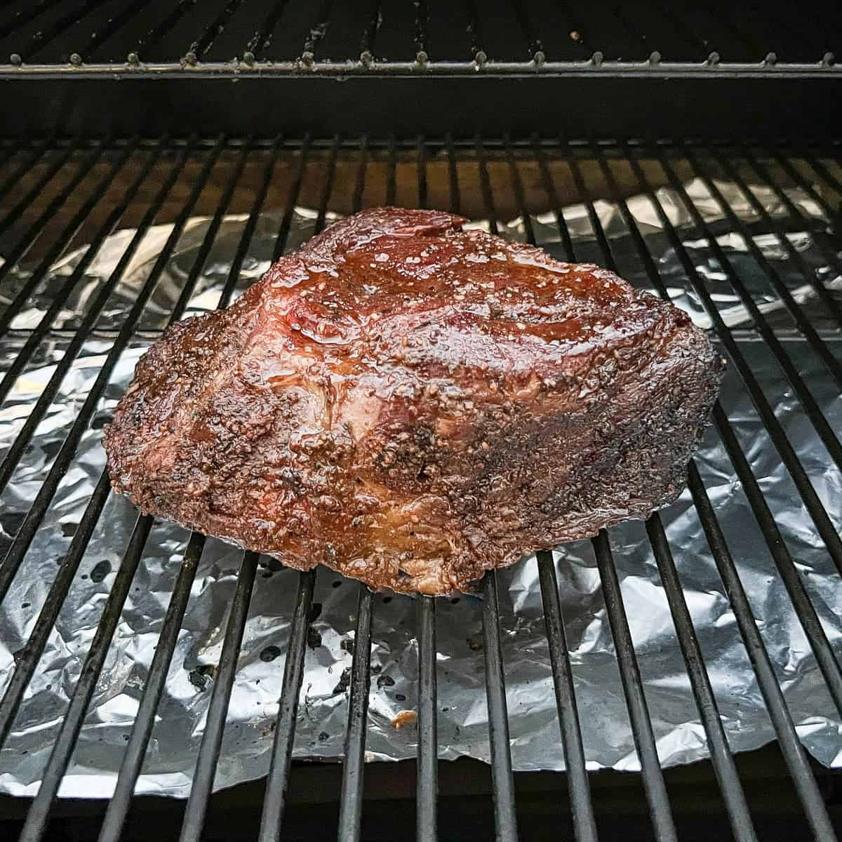 Chuck roast on the grates of a Traeger pellet grill