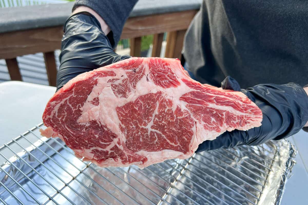 a raw prime rib roast shown from the side