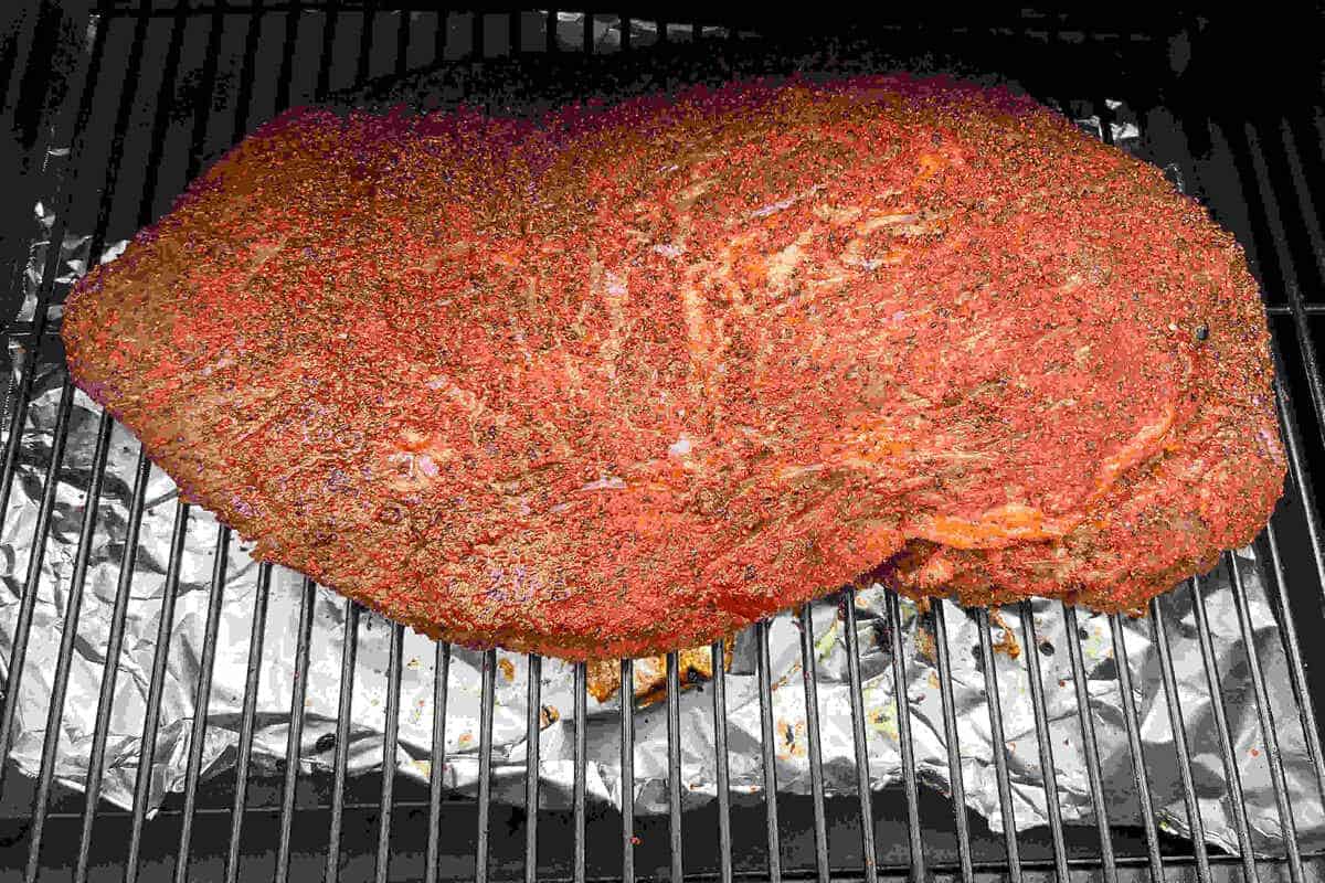 a beef brisket on the grates of a Traeger