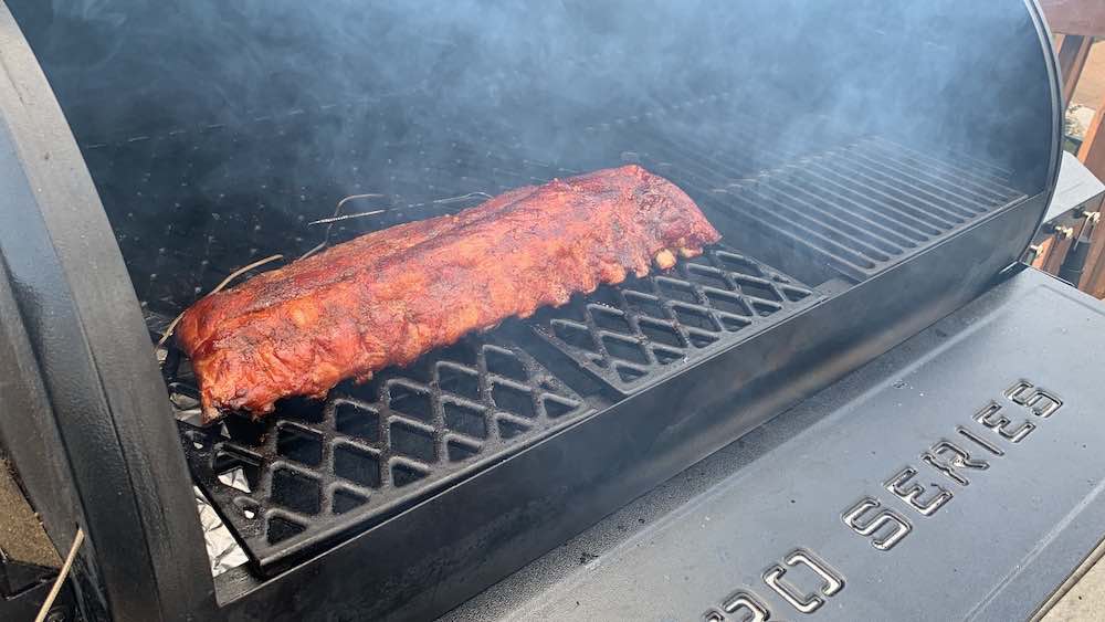 putting unwrapped baby back ribs back on pit boss pellet smoker