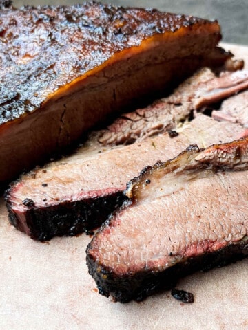 smoked beef brisket sliced on a wood cutting board