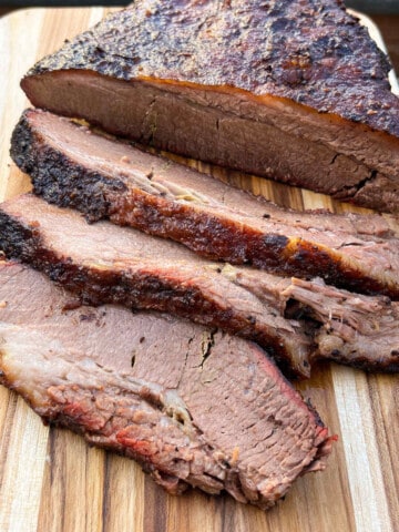 smoked brisket sliced on a wooden cutting board