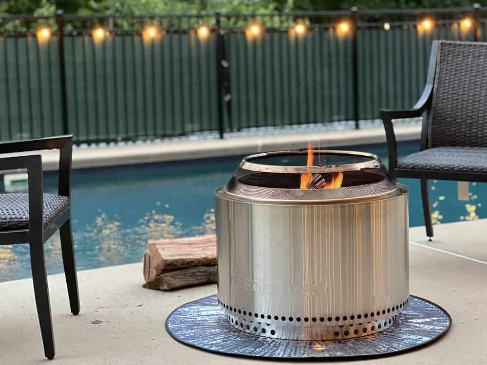 Lit solo stove on concrete pool deck