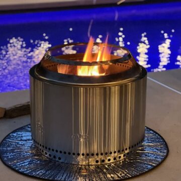 Solo stove burning on concrete by pool