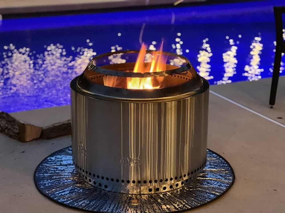 Solo stove burning on concrete by pool