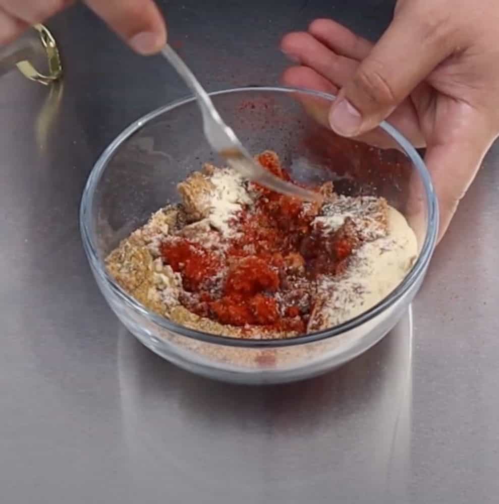 mixing chicken wing rub ingredients together in a bowl