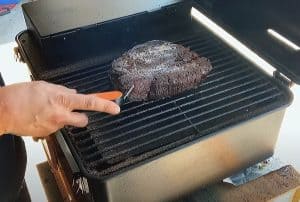 checking the internal temperature of a smoked chuck roast on a traeger