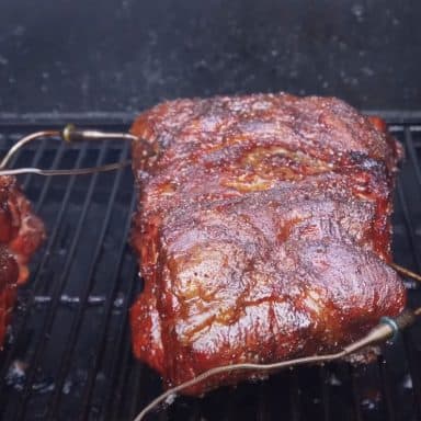 a pork butt smoking on a camp chef pellet grill