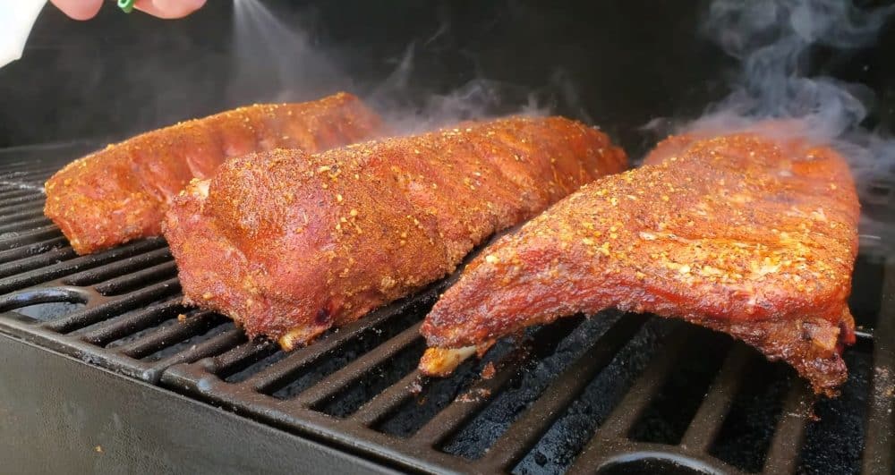 spritzing baby back ribs on a pit boss pellet grill