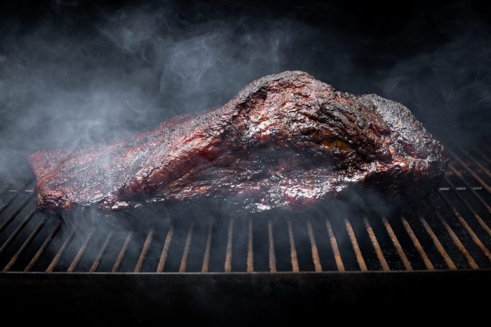a beef brisket smoking on a traeger pellet grill