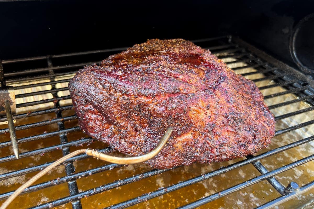 smoked chuck roast on the top rack of a pit boss pellet grill ready to be wrapped in butcher paper