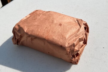 a chuck roast wrapped up in pink butcher paper