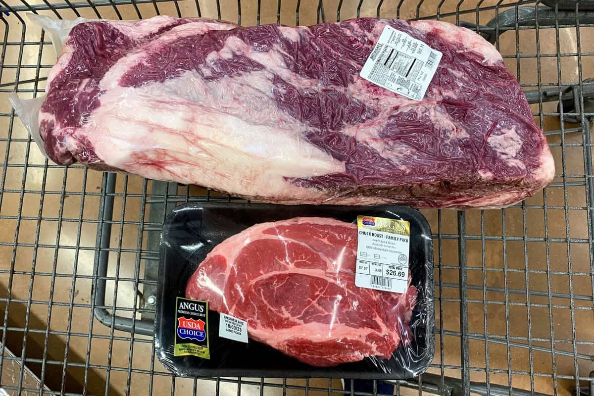 grocery store cart containing a large brisket and a large chuck roast