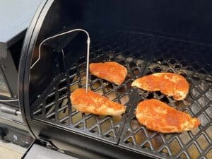 chicken breasts smoking on a pit boss pellet grill