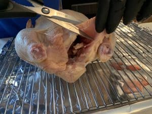trimming a raw whole chicken
