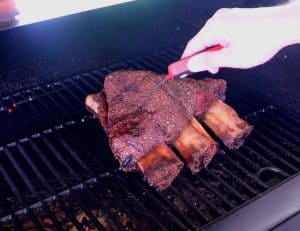 checking temperature on smoked beef ribs