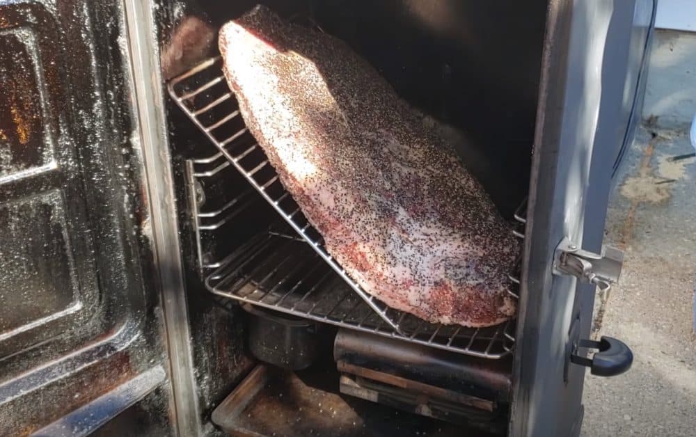 a full packer brisket fitting into a masterbuilt electric smoker